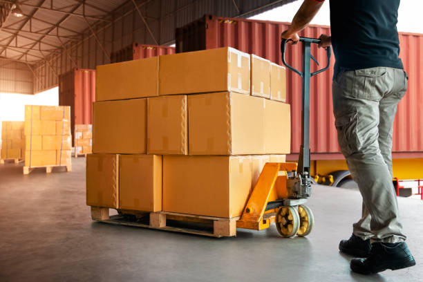 istock Workers Unloading Packaging Boxes on Pallets in Warehouse. Cartons Cardboard Boxes. Shipping Warehouse. Delivery. Shipment Goods. Supply Chain. Supplies Distribution Warehouse Logistics 1428910431