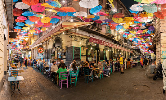 Catania, Sicily - September 21, 2022: Old town with colorful umbrellas over the street in Catania, Sicily island, Italy