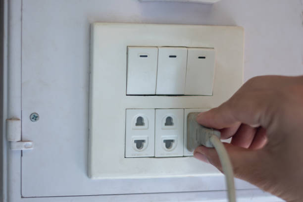 istock Closeup hand unplug electricity, save power and energy home and routine concept copy space for text and design 1428914665