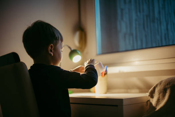 istock Boy is doing his homework at the desk 1428916339