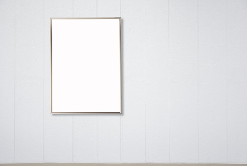 Blank metal picture frame mockup on white wall
