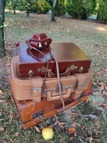 Vintage old classic travel leather suitcases on the camera