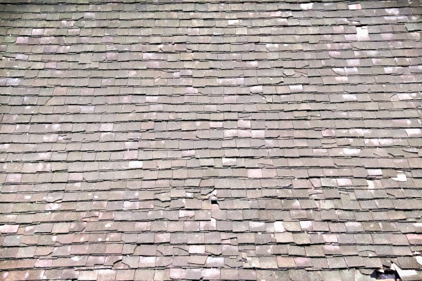 istock Old tile roof with decay and broken on background 1428923390