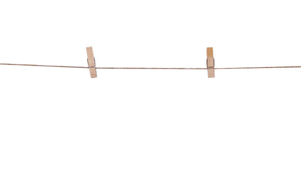 istock Two wood clothes pegs hanging on brown string line isolated on white background , clipping path 1428923487