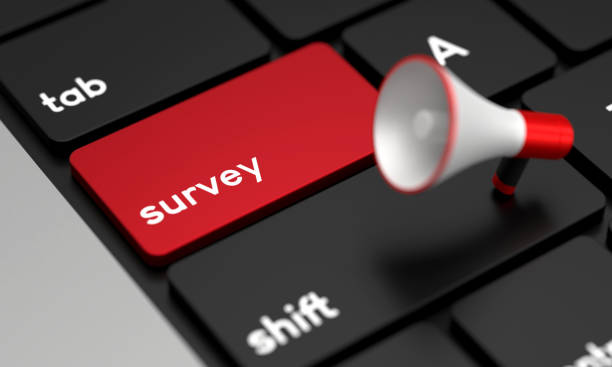 istock Close-Up Laptop Keyboard With Survey Button and Megaphone 1428926311