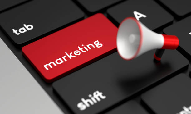 istock Close-Up Laptop Keyboard With Marketing Button and Megaphone 1428926977