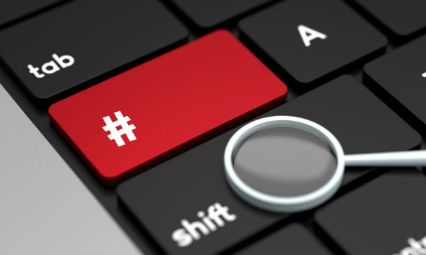 istock Close-Up Laptop Keyboard With Hashtag Button and magnifying glass 1428927231
