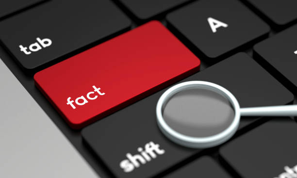 istock Close-Up Laptop Keyboard With Fact Button and magnifying glass 1428928670