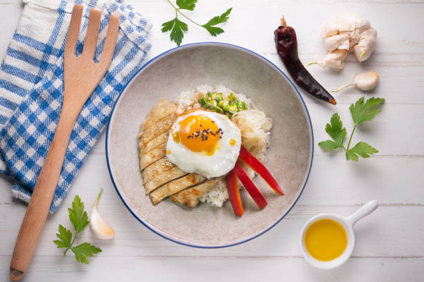 istock Teriyaki chicken donburi with fried egg, onion, red pepper and other vegetables. Typical Japanese dish. 1428930589