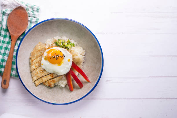 istock Teriyaki chicken donburi with fried egg, onion, red pepper and other vegetables. Typical Japanese dish. 1428930619