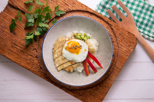 istock Teriyaki chicken donburi with fried egg, onion, red pepper and other vegetables. Typical Japanese dish. 1428930638