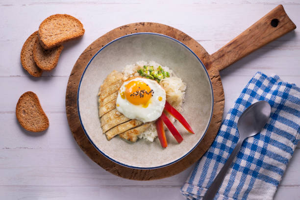 istock Teriyaki chicken donburi with fried egg, onion, red pepper and other vegetables. Typical Japanese dish. 1428930644