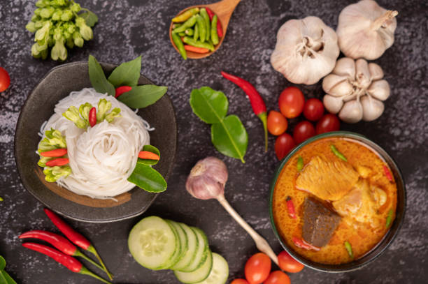 istock Chicken curry in a black cup with rice noodles. 1428931483