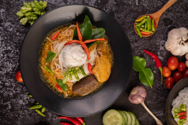 istock Chicken curry in a black cup with rice noodles. 1428931730