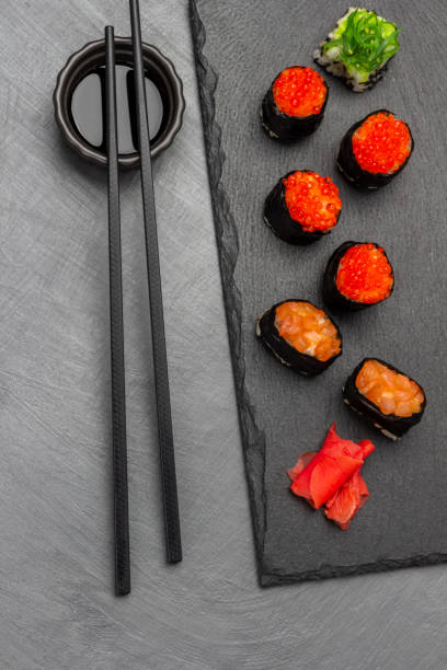 istock Sushi with caviar and salmon on stone board. 1428935279