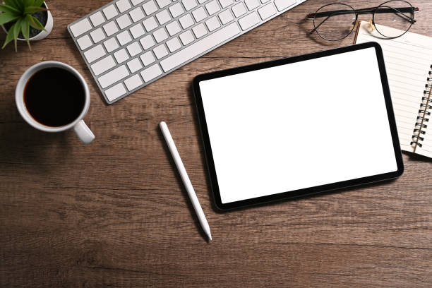 istock Modern workplace, digital tablet, stylus pen, coffee cup and notebook on wooden table. Top view, Flat lay. 1428937058