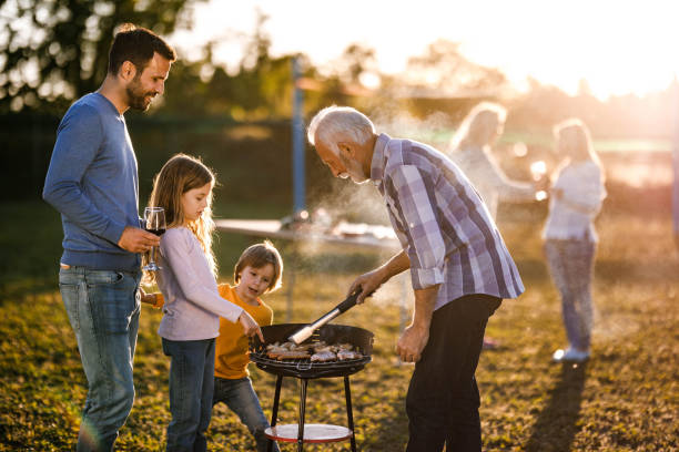 istock Extended family having barbecue time in the front yard. 1428937387