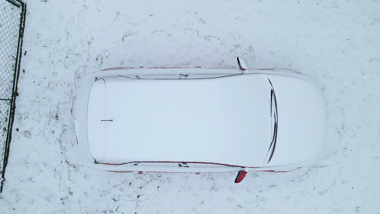 Red car covered with the snow