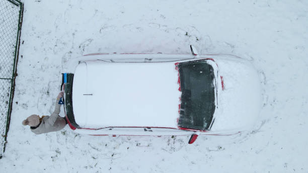 istock Woman scraping ice from her car 1428937872