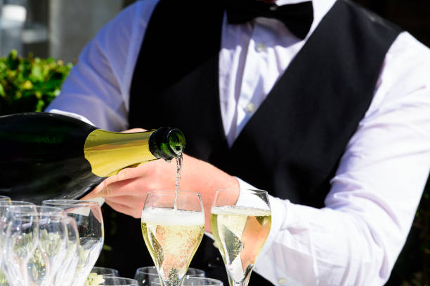 istock pooring champagne into a champagne flute 1428940947