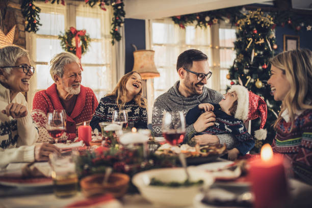 istock Happy multi-generation family having fun during New Year's lunch at dining table. 1428940959