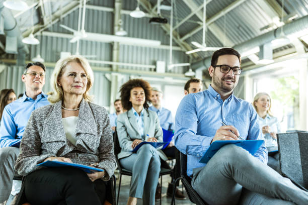 istock Large group of business people attending a training class in a board room. 1428941590