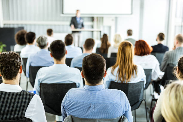 Rear view of business seminar in a board room. stock photo