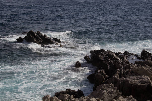 istock rough sea slamming against the rocks 1428942470