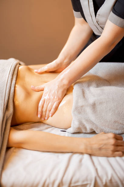 istock Masseuse performs professional abdominal massage for a woman 1428944394