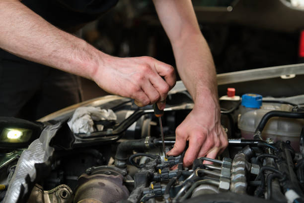 istock Technician removing fuel injectors checking dust and test pressure. 1428944528