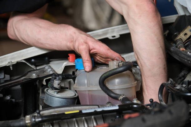 istock Car mechanic checking pulley on a car engine. 1428944660