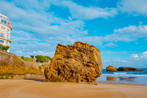 a detail of the peculiar big rock on the sand of the La Grande Plage Beach in Biarritz, France, early in the morning in a summer day