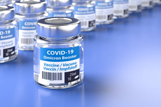 Concept for availability of enough booster vaccine against Covid-19 Omicron variant: Bottles of vaccination. The word vaccination in English, Spanish, French and German on the label stock photo