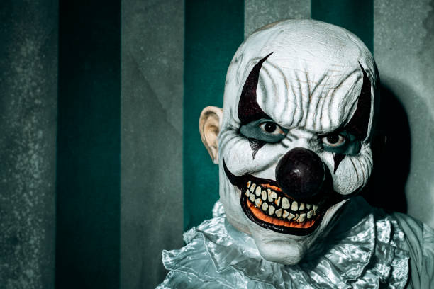 istock creepy evil clown in an old circus 1428948522