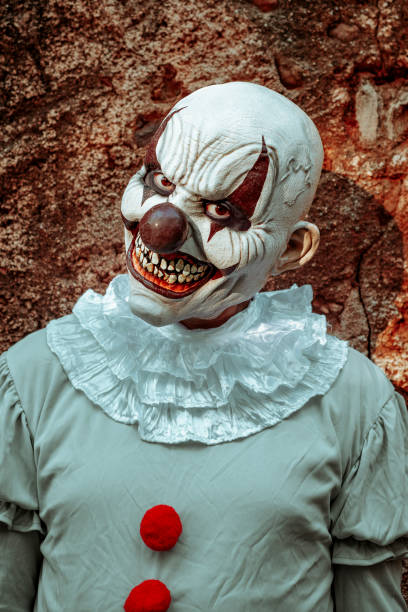 istock evil clown staring at the observer in an old house 1428949114