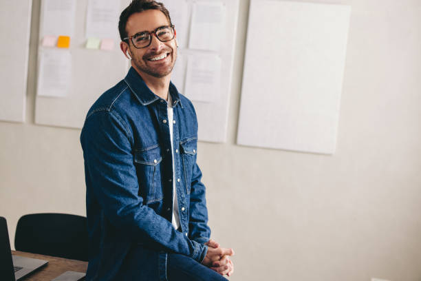 istock Happy young businessman having a conference call using earbuds 1428950455