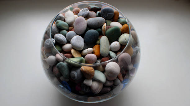 Stack of sand and small pebbles on white background