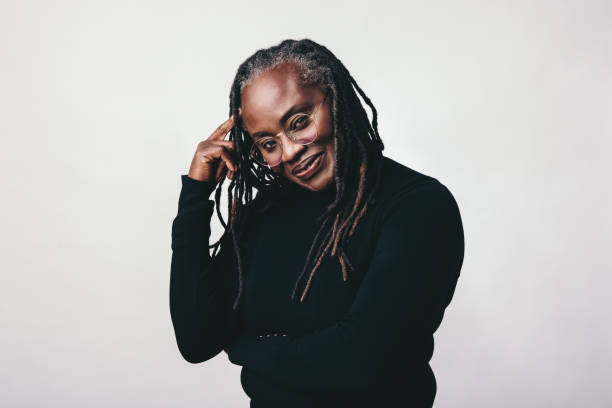 istock Middle aged woman with dreadlocks looking at the camera in a studio 1428953092