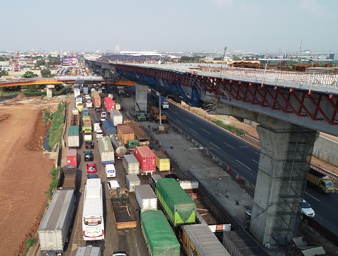 Jakarta, Indonesia in August 2019. Aerial view photo of cars and trucks that are in a toll road jam. When stuck the vehicle runs slowly and sometimes stops.