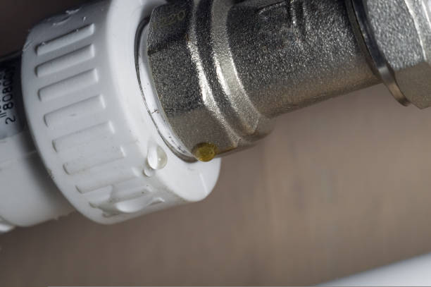 istock Leakage heating system. Problem with water leakage at the junction of pipes and radiators of the home heating system. Water leakage with poor tightness of threaded pipe connections. Selective focus 1428954662
