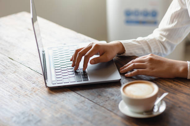 istock latte coffee cup Asian woman working with laptop in a cafe 1428956621