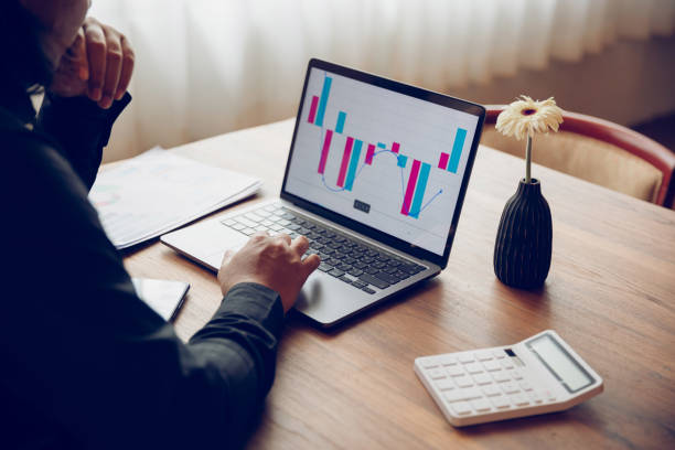 istock Business man or accountant working on laptop computer with business document, graph diagram and calculator on office table 1428956704