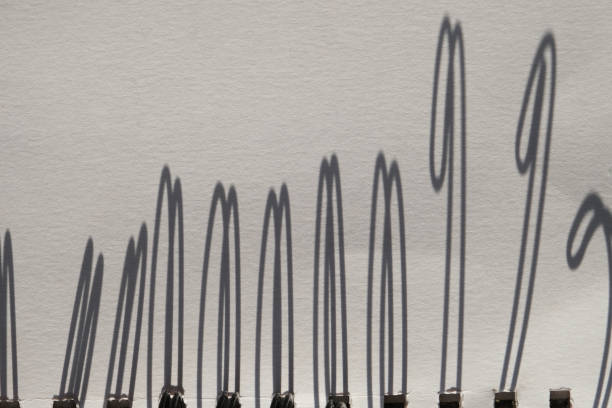 istock Shadow of bent wire binding a spiral notebook. Elegant Minimalist monochrome abstract 1428957789
