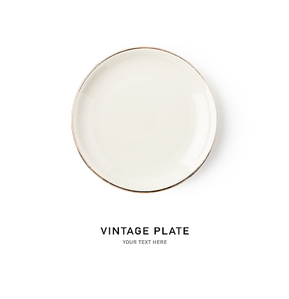 Empty white plate with gold rim isolated on white background. Vintage dish. Kitchen utensil. Top view, flat lay. Design element