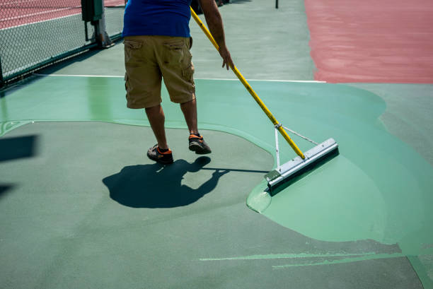 man is painting tennis hard court horizotal photo stock photo