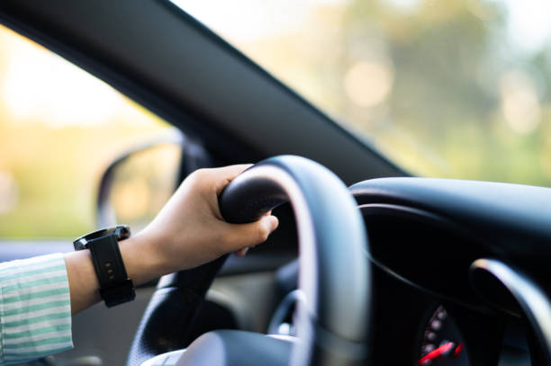 istock Asian young woman driving car 1428975435