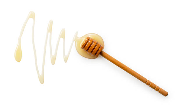 istock Wooden honey dipper with honey on white background. 1428979800