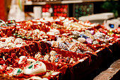 Colorful close up details of christmas fair market. Balls decorations for sales. Xmas market in Germany with traditional decorative toys.