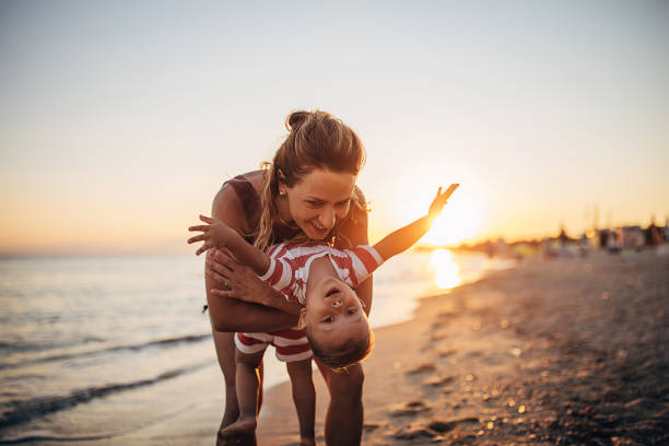 istock A mother playing with her son on the beach 1428985853