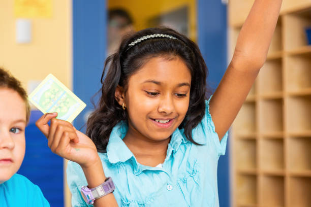 istock School children playing card game 1428987896